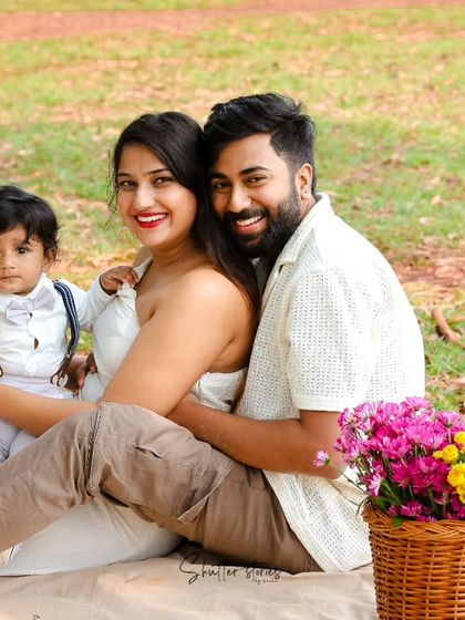 A sweet moment during the family picnic, with the parents and their son sharing a happy moment.