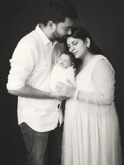 A classic black and white family portrait that becomes an instant heirloom. In this quiet, timeless frame, all that matters is the connection between new parents and their precious baby. This is the kind of powerful, emotive photography I create to tell your family's story for generations.