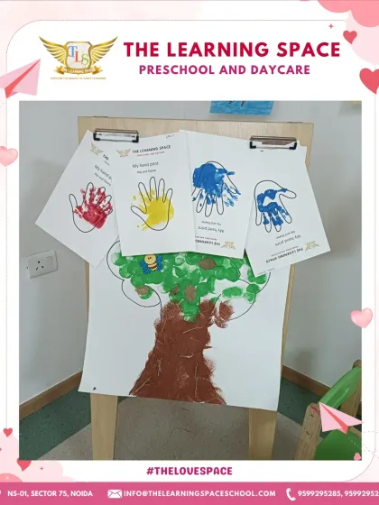 The finished handprint artwork displayed on an easel. Showcasing children's work builds their self-esteem and makes them feel like valued members of our creative community.