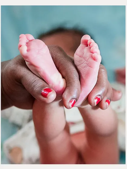 The tiniest feet held in loving hands. We focus on these delicate details during our newborn sessions, preserving the memory of just how small they once were.