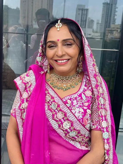 A joyful portrait capturing the radiant makeup look for the Paryushan festival. The focus was on creating a luminous base and defining the eyes to complement her festive attire.