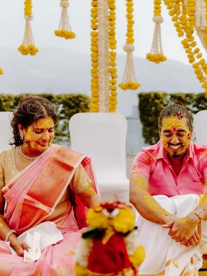 A beautiful, candid moment from a Haldi ceremony. Our decor aims to create a joyful and vibrant backdrop for these precious family moments.