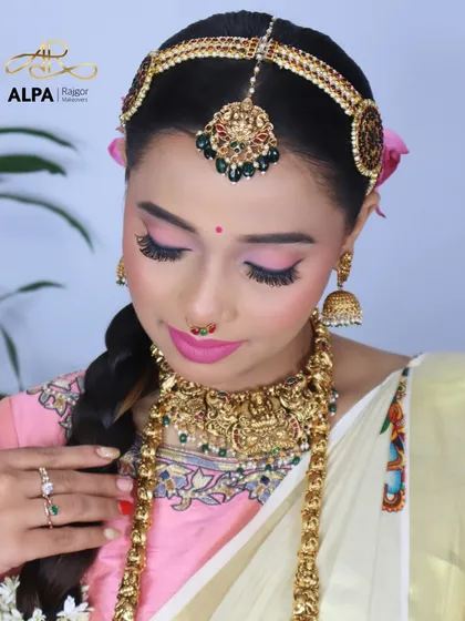 This shot focuses on the intricate details of the temple necklace and the matha patti.