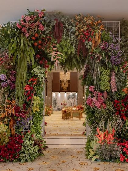 A grand floral archway at the entrance to the 'Orchard of Life' naming ceremony.
