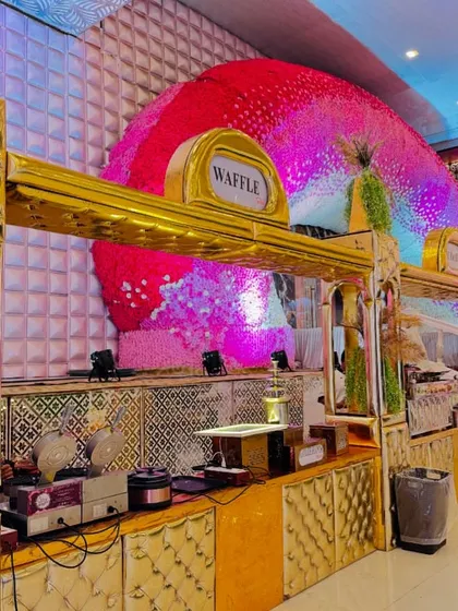 The grand, golden waffle station, set against a magnificent floral backdrop, showcasing the scale of my dessert setups.