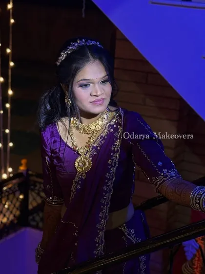 The bride making her entrance during the Bandoli. The purple lehenga is a unique and stunning choice, and the makeup complements it perfectly.