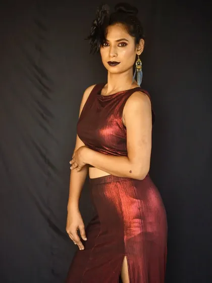 A confident pose that captures the essence of this bold and creative makeup style.