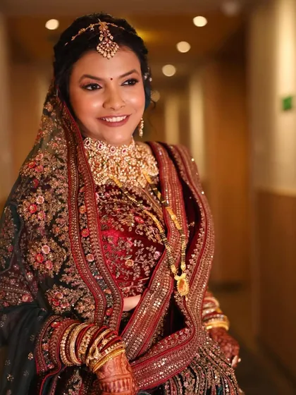 A stunning portrait of the bride in her reception lehenga. The makeup is glamorous yet elegant, perfect for celebrating her new beginning.