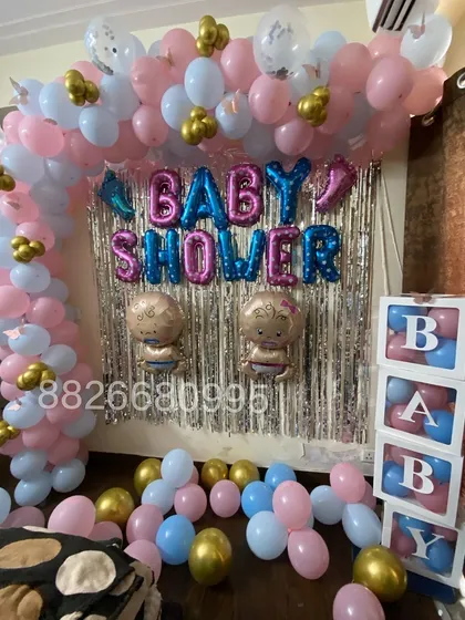This angle highlights the 'BABY' blocks filled with pink and blue balloons, a popular addition for baby showers and gender reveal parties.