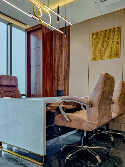 A view of the executive cabin we designed for the Sun Group office. The space combines a solid marble desk with warm, fluted wood paneling and contemporary lighting to project an image of authority and refined taste.