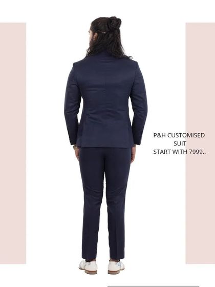 A view from the back of the classic navy blue suit, highlighting the quality of the fit and tailoring.