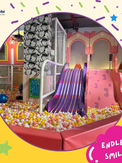 Endless smiles are guaranteed in our play area. This shot captures the pure joy of sliding into our massive, colorful ball pit.