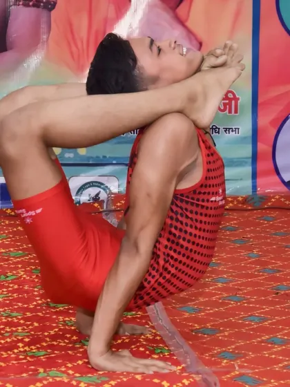 A deep contortion pose performed on stage. This requires complete trust in your body and your training.