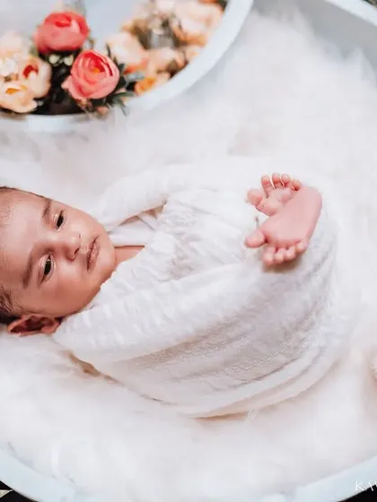 It's always special when we catch a glimpse of a newborn's eyes. This little one was awake for a moment, allowing me to capture a calm and curious expression during the session.