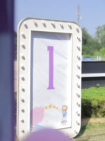 A light-up marquee sign displaying the number '1' for a first birthday carnival. The simple, elegant design with a small circus graphic is perfect for capturing milestone photos.