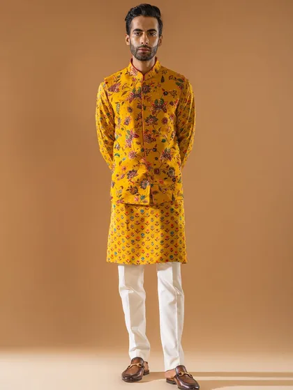 Vibrancy and artistry come together in this striking yellow Jawahar jacket and kurta set. The bold floral print on the jacket, paired with a patterned kurta, makes it an impeccable choice for a vibrant Mehendi or Haldi ceremony.