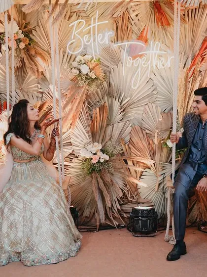 Our 'Better Together' swing photo-op in action. This was designed for an engagement party, using pampas grass and dried palms to create a trendy, boho-chic backdrop that the couple and guests loved.