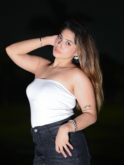 A classic portrait pose, using flash photography to create a sharp, high-fashion look.