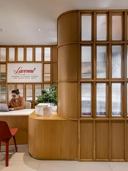The elegant wood and glass design of our Delhi reception creates a sophisticated first impression.