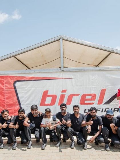 The Birel ART India team, including mechanics, coaches, and drivers, posing together. This is the support system behind every victory.
