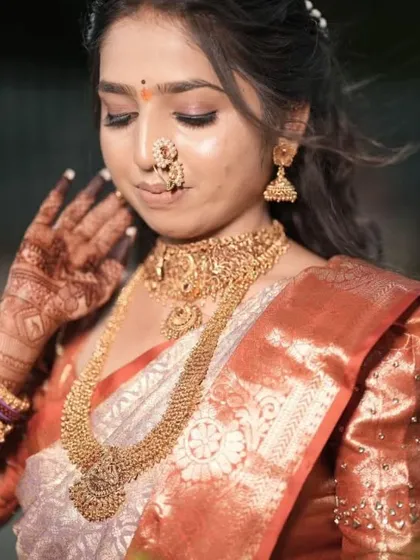 Another portrait of the same bride, showcasing her stunning gold jewelry which pairs beautifully with the warm tones of her henna.