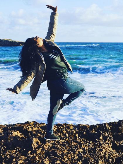 Striking a dance pose by the ocean. The power and rhythm of the waves are a huge inspiration for fluid and graceful movements.