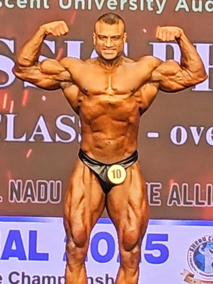 Hitting the front double biceps at the NPC Nationals. Even from a phone camera, the conditioning and muscle fullness are visible. This is the result of a well-executed peak week.