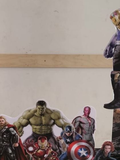 A custom Avengers photo booth prop, allowing guests to pose with their favorite heroes like the Hulk and Thanos.