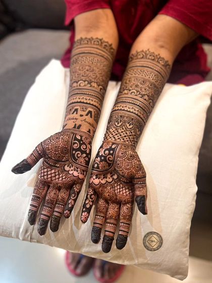 A full view of Amrutha's engagement henna. The design is dense and symmetrical, featuring a mix of floral elements and traditional Indian patterns perfect for the occasion.