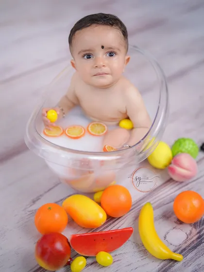 After the cake smash comes the splash! A warm, gentle milk bath session is a delightful way to clean up and capture even more adorable photos, complete with colorful, baby-safe fruit props.