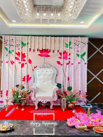 For a traditional Seemantham, we created this elegant stage with an ornate white throne chair for the mother-to-be. The backdrop, adorned with lotus and hummingbird motifs and framed by fresh tuberose garlands, sets a serene and sacred tone for the ceremony.