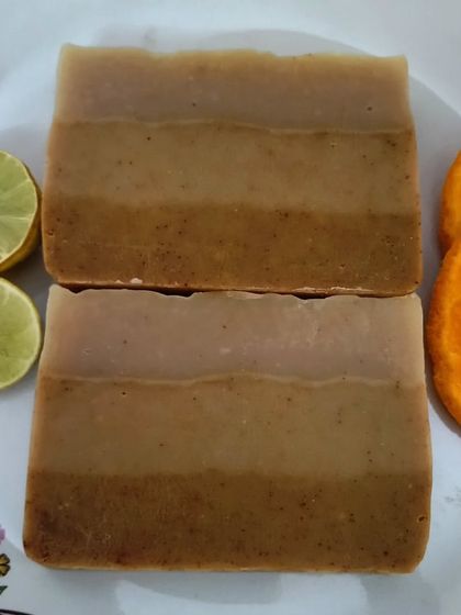 Fresh & Juicy soap bars displayed with fresh orange and lemon slices to highlight their natural citrus ingredients.