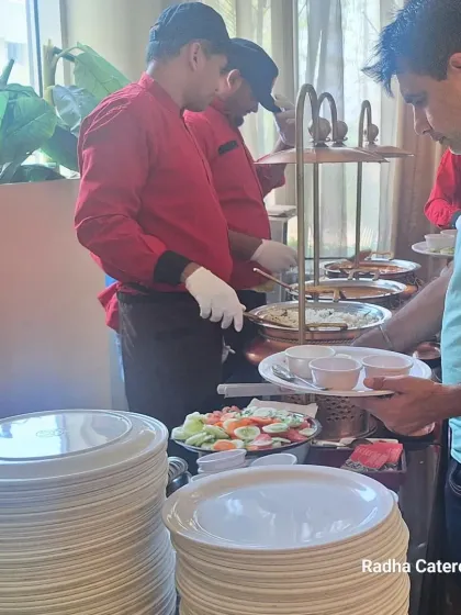 Service is just as important as the food itself. My staff are shown here serving guests at a naming ceremony, ensuring everyone gets what they need. This level of attention is standard for us, whether it's a corporate conference or a private celebration.