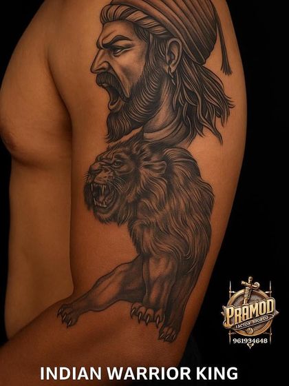 An ad showcasing a powerful warrior king and lion tattoo. This type of large-scale bicep work is one of our specialties, perfect for making a bold statement.