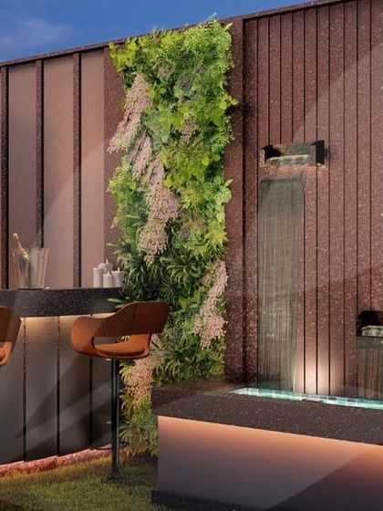 We love combining different textures. This bar area design pairs a lush vertical garden with a sleek waterfall feature, creating a beautiful contrast between soft greenery and flowing water.