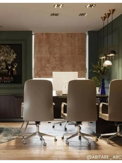 A view of the Armonia office, where we used a deep green wall color and contemporary furniture. The space is designed to be both professional and inspiring, with artwork and modern lighting fixtures adding character.