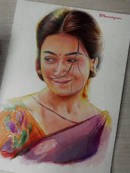 A colored pencil and pen portrait of Srivalli from the movie Pushpa. I used a mix of colors to capture the softness of her expression and the vibrant colors of her saree.