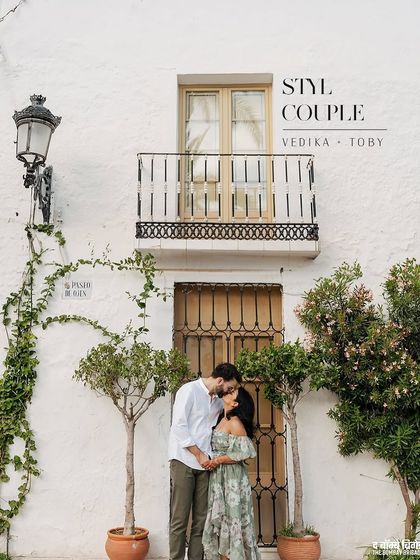 Before the vows, a quiet kiss against a charming Spanish facade. Their coordinated looks feel effortless and romantic, allowing their connection to be the focus of the frame.