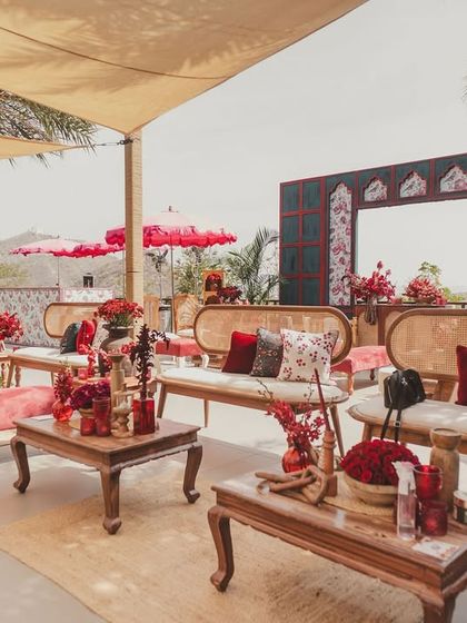 The comfortable lounge seating at the Haldi, with rattan benches and plush red cushions inviting guests to relax and soak in the festive atmosphere.
