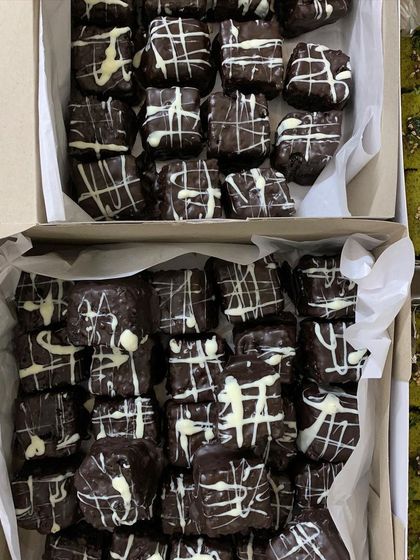Boxes of my eggless Double Chocolate Brownies, a perfect sweet addition to a catered dinner party.
