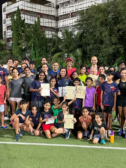 Celebrating a session well done. This is our community of kids and adults, all smiles after pushing their limits together on the field.