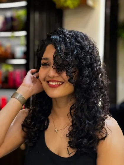 It was an absolute pleasure giving the talented actress Ritika Singh a curly makeover. We went for a cut that added shape and volume, styling it to create these soft, defined curls that perfectly frame her face.