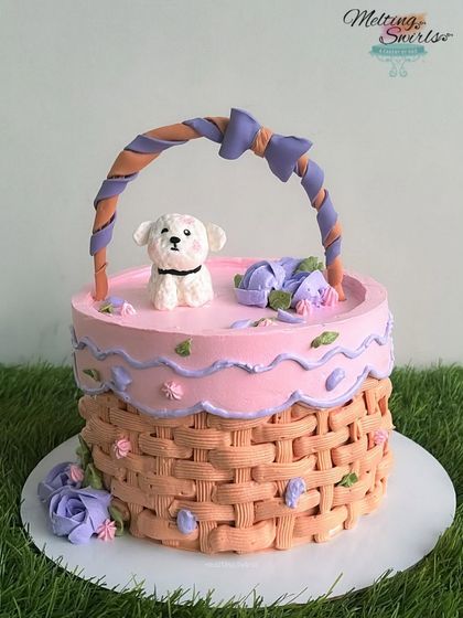 This cute flower basket cake was made for a regular client who always pushes our creativity. The basket weave is piped with whipped cream, and it's topped with a sweet fondant puppy.