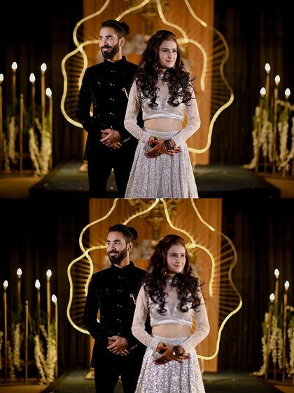 The couple posing on stage during their engagement ceremony in Orchha. The unique decor and warm lighting make for a memorable and artistic photograph.