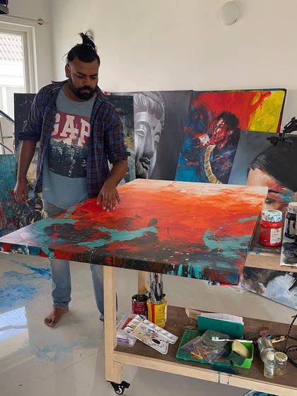 A candid shot of me in the studio, barefoot and focused on the canvas. This is my element.