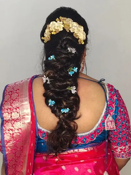 A creative and beautiful braided hairstyle, decorated with small blue and white flowers for a unique touch.