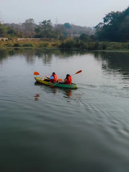A peaceful shot of two people kayaking on the lake, a perfect way to connect with nature.
