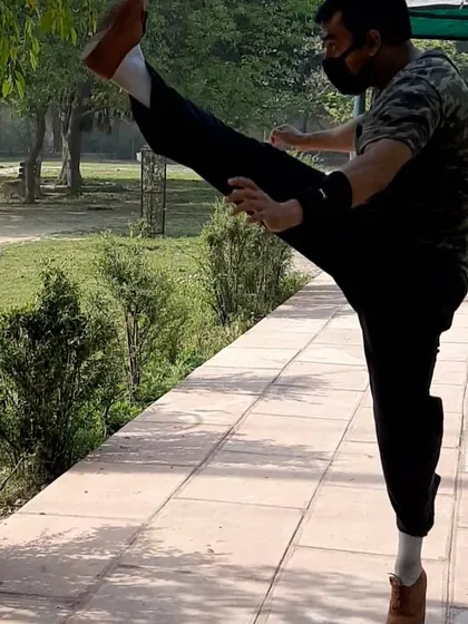 Consistency is the key to maintaining a high level of skill. This is another look at a high kick, showing the straight leg and stable posture needed for maximum height and power.