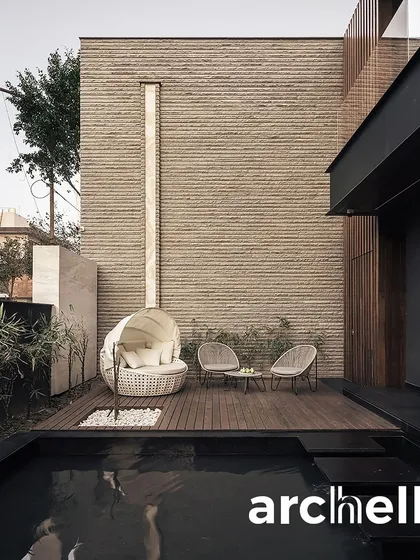 This private poolside deck from our Carbonado project offers a secluded spot for relaxation. The design uses natural materials like brick and wood to create a warm, tactile environment that feels both modern and timeless.