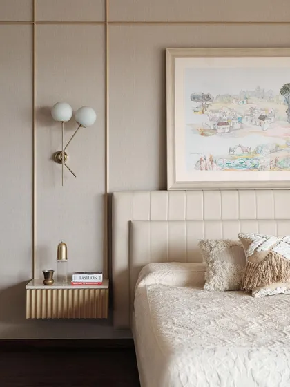 In this master bedroom, I aimed for a calm and sophisticated retreat. The design features a fabric-panelled wall, bespoke fluted bedside tables, and soft, layered textiles to create a warm and inviting atmosphere. The artwork was chosen to complement the serene, neutral tones of the room.
